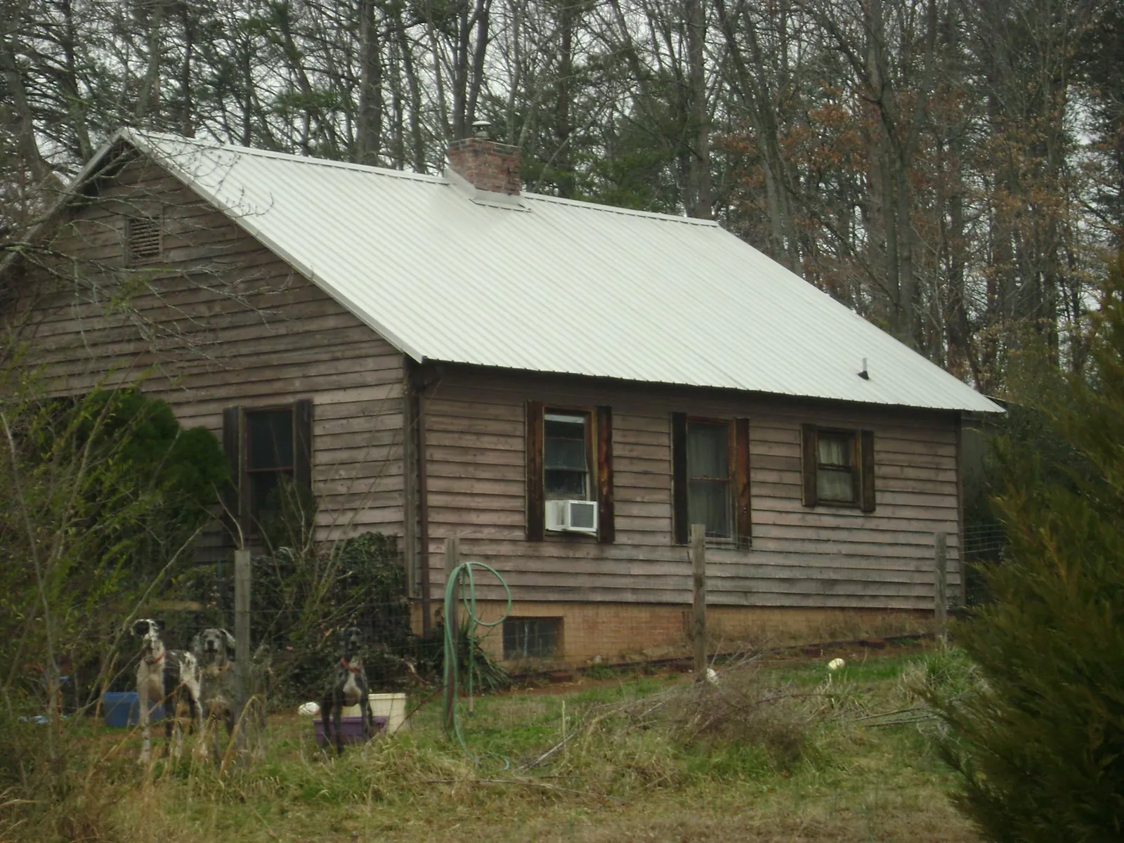 White metal roof on an old wood sided farmhouse, from a Metal Roof Installation job in Washingtonville